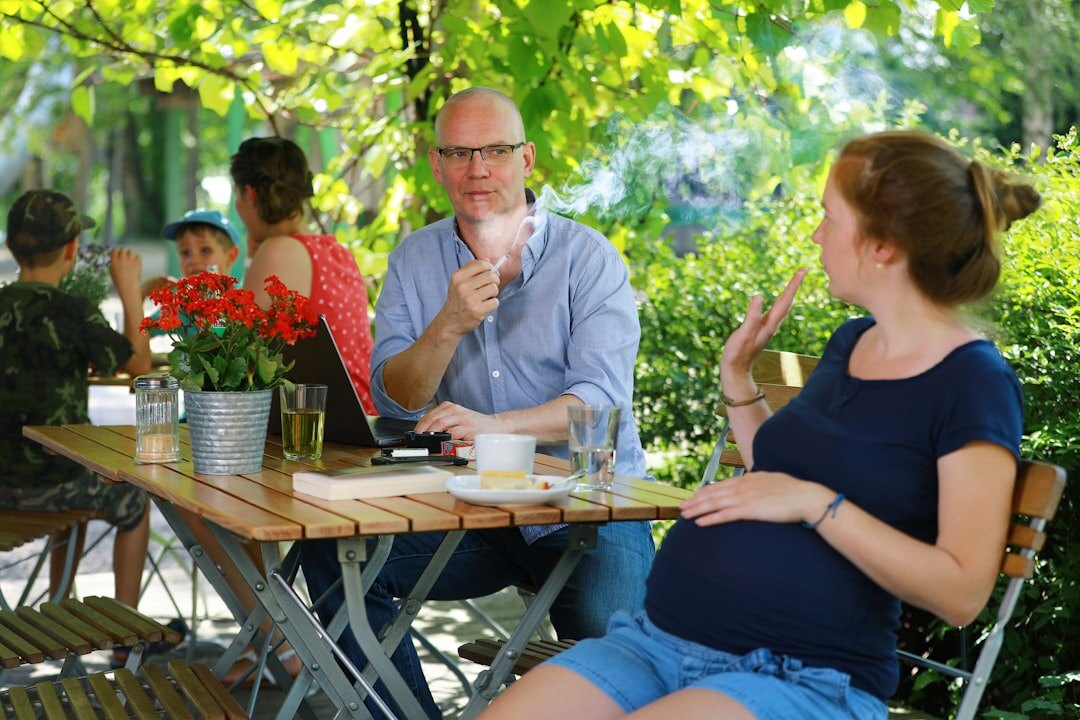 Journalist interviewing an expert with a recorder on the table outdoors